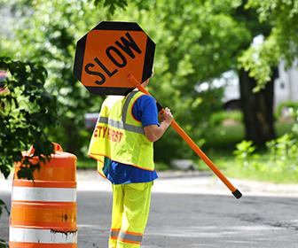 Safety Worker holding a sign that reads Slow